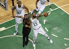 Cleveland Cavaliers center Tristan Thompson, front left, and Boston Celtics forward Marcus Morris, right, fight for the ball during the first half in Game 7 of the NBA basketball Eastern Conference finals, Sunday, May 27, 2018, in Boston. (AP Photo/Charles Krupa)
