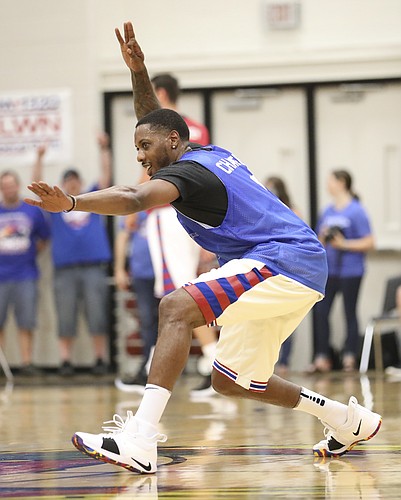 Blue Team guard Mario Chalmers celebrates after hitting a three to end the half during the Rock Chalk Roundball Classic on Thursday, June 14, 2018 at Free State High School.
