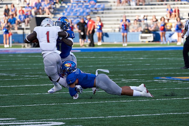 Kansas safeties Bryce Torneden (1) and Mike Lee (11) tackle Nicholls State running back Dontrell Taylor (1) during the first half on Saturday, Sept. 1, 2018 at Memorial Stadium. 
