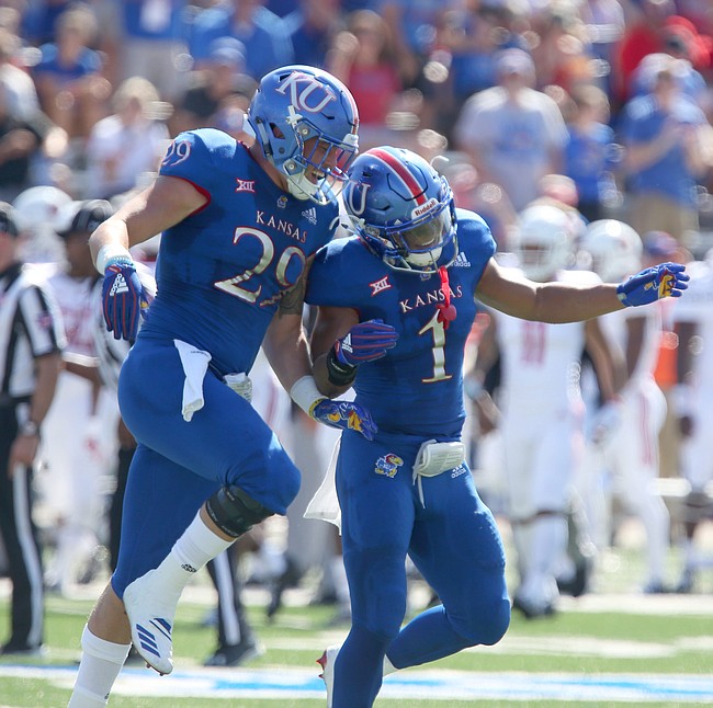 Kansas linebacker Joe Dineen Jr. (29) and Kansas safety Bryce Torneden (1) celebrate a defensive stop during the first quarter on Saturday, Sept. 15, 2018 at Memorial Stadium.
