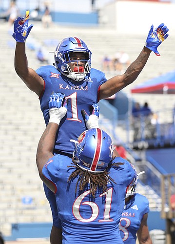 Kansas running back Pooka Williams Jr. (1) is hoisted up by Kansas offensive lineman Malik Clark (61) after a touchdown during the fourth quarter on Saturday, Sept. 15, 2018 at Memorial Stadium.