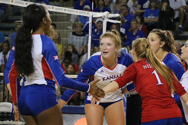 Senior right side Gabby Simpson talks with her team after a Kansas point. Simpson had seven blocks in the team's 3-1 win over Drake Tuesday night.