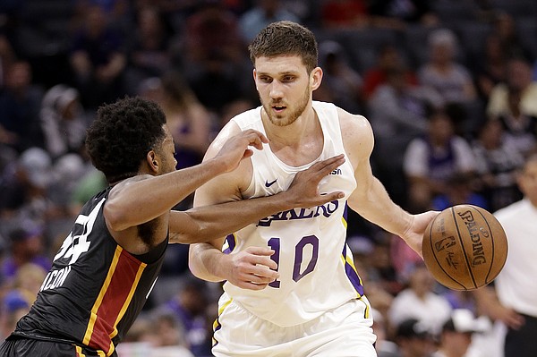 Los Angeles Lakers forward Sviatoslav Mykhailiuk, right, drives against Miami Heat guard Daryl Macon during the second half of an NBA summer league basketball game Tuesday, July 3, 2018, in Sacramento, Calif. (AP Photo/Rich Pedroncelli)