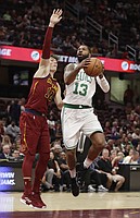 Boston Celtics' Marcus Morris (13) drives against Cleveland Cavaliers' Cedi Osman (16) in the first half of an NBA preseason basketball game, Saturday, Oct. 6, 2018, in Cleveland. (AP Photo/Tony Dejak)