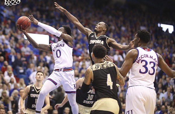 Kansas guard Marcus Garrett (0) swoops to the bucket past Emporia State forward Hassan Thomas (3) during the first half of an exhibition, Thursday, Oct. 25, 2018 at Allen Fieldhouse.