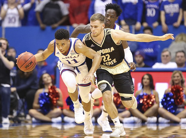 Kansas guard Devon Dotson (11) pushes the ball up the court against Emporia State guard Jack Dale (22) during the first half of an exhibition, Thursday, Oct. 25, 2018 at Allen Fieldhouse.