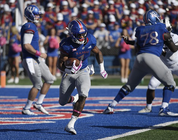 Pooka Williams runs through the TCU defense Saturday at David Booth Kansas Memorial Stadium. The Jayhawks claimed a 27-26 win over the Horned Frogs, which ended their 14-game skid in league play.