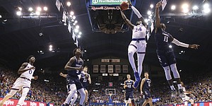Kansas guard Lagerald Vick (24) gets to the bucket past Washburn guard Tyas Martin (13) during the first half of an exhibition, Thursday, Nov. 1, 2018, at Allen Fieldhouse.
