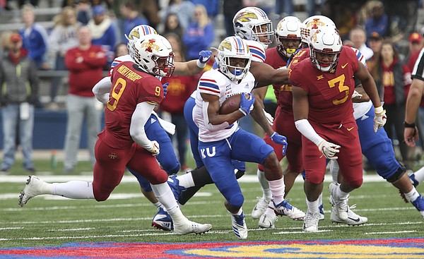 Kansas running back Pooka Williams Jr. (1) tries to escape Iowa State linebacker Reggan Northrup (9) and Iowa State defensive end JaQuan Bailey (3) during the second quarter, Saturday, Nov. 3, 2018 at Memorial Stadium.