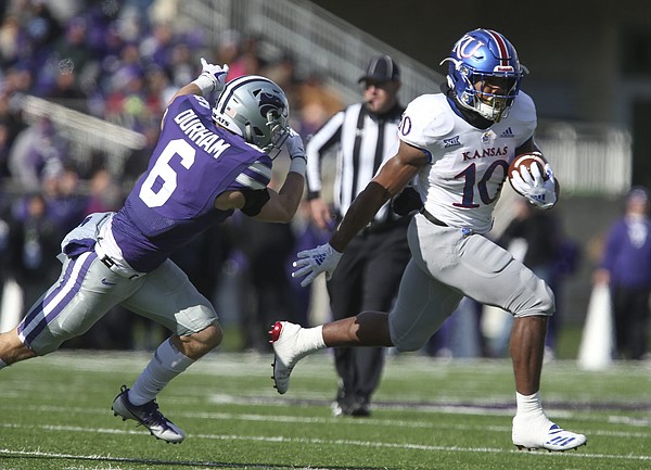 Kansas running back Khalil Herbert (10) leaves Kansas State defensive back Johnathan Durham (6) as he takes off up the field for a long run during the third quarter on Saturday, Nov. 10, 2018 at Bill Snyder Family Stadium in Manhattan, Kan.