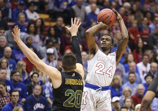 Kansas guard Lagerald Vick (24) puts up a three over Vermont guard Ernie Duncan (20) during the first half, Monday, Nov. 12, 2018 at Allen Fieldhouse.