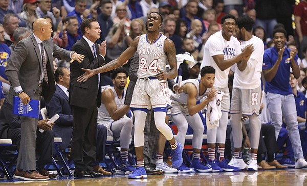 Kansas guard Lagerald Vick (24) slaps hands with assistant coach Fred Quartlebaum after a defensive stop during the first half, Monday, Nov. 12, 2018 at Allen Fieldhouse.