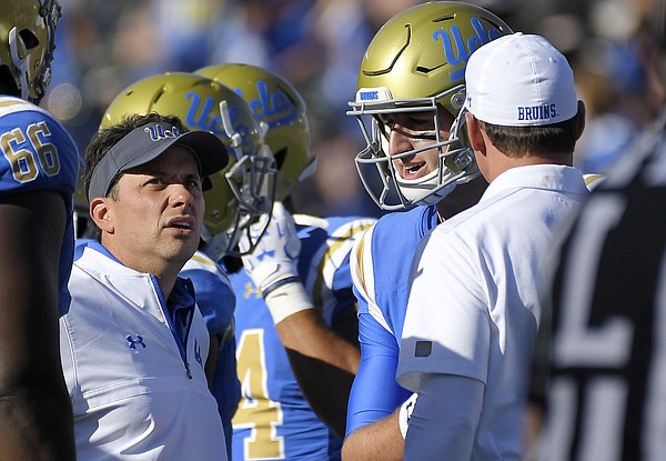 UCLA offensive coordinator Jedd Fisch, left, talks with quarterback Josh Rosen, center, and head coach Jim Mora during the second half of an NCAA college football game against Oregon, Saturday, Oct. 21, 2017 in Pasadena, Calif. UCLA won 31-14. (AP Photo/Mark J. Terrill)