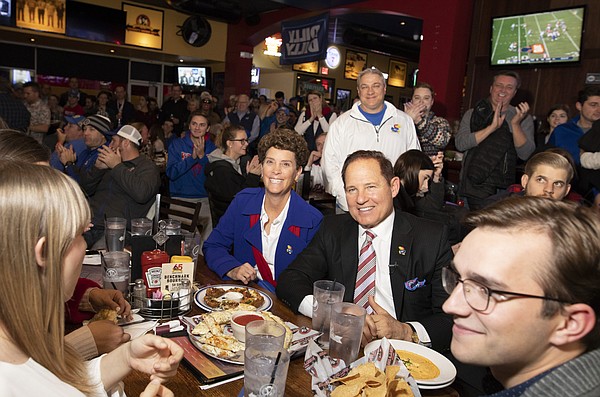 Newly-hired Kansas head football coach Les Miles sits next to his wife, Kathy, as they listen to Kansas Athletic Director Jeff Long tell a story about hiring Miles during the "Hawk Talk" radio show on Sunday, Nov. 18, 2018, at Johnny's West in Lawrence. Miles was announced as the head coach earlier in the day.
