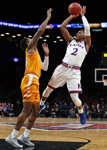 Kansas guard Charlie Moore (2) shoots over Tennessee guard Jordan Bowden (23) during the first half of an NCAA college basketball game in the NIT Season Tip-Off tournament Friday, Nov. 23, 2018, in New York. (AP Photo/Adam Hunger)