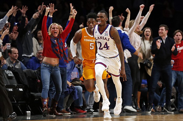 Kansas guard Lagerald Vick (24) reacts after making a 3-point basket, in front of Tennessee guard Admiral Schofield (5) during the second half of an NCAA college basketball game in the NIT Season Tip-Off tournament Friday, Nov. 23, 2018, in New York. Kansas defeated Tennessee 87-81 in overtime. (AP Photo/Adam Hunger)