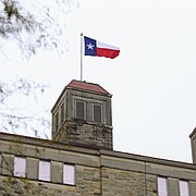 A Texas flag flies atop Fraser Hall on the University of Kansas campus on Friday, Nov. 23, 2018. An apparent prank, the flag was flying during part of KU's home football game versus the University of Texas before being reported and taken down about noon.