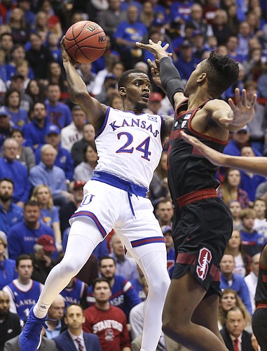 Kansas guard Lagerald Vick (24) looks for an outlet while defended by Stanford forward KZ Okpala (0) during the first half on Saturday, Dec. 1, 2018 at Allen Fieldhouse.