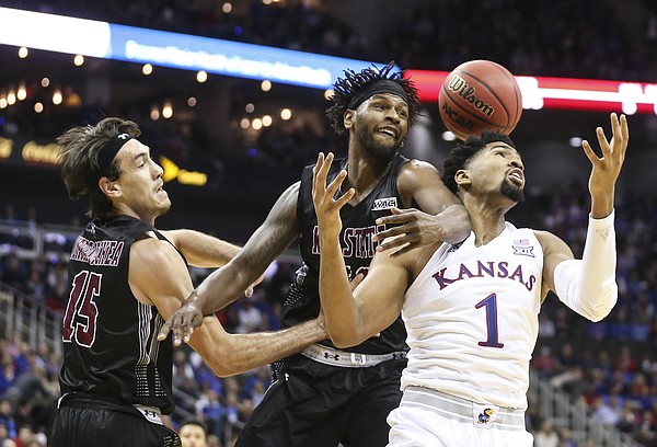 Kansas forward Dedric Lawson (1) tangles with New Mexico State forward C.J. Bobbitt (13) and New Mexico State forward Ivan Aurrecoechea (15) as they fight for a rebound during the first half on Saturday, Dec. 8, 2018 at Sprint Center.