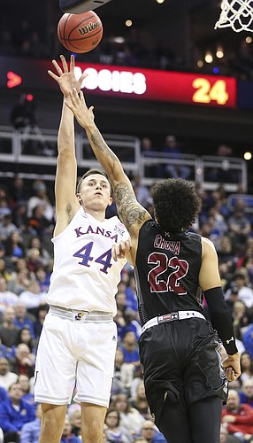 Kansas forward Mitch Lightfoot (44) turns for a shot over New Mexico State forward Eli Chuha (22) during the first half on Saturday, Dec. 8, 2018 at Sprint Center.