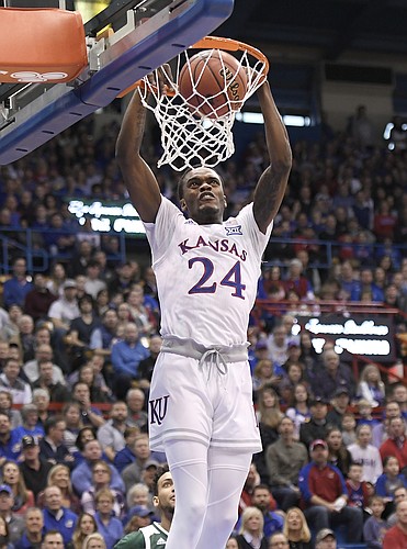 Kansas guard Lagerald Vick throws down a two handed dunk Saturday.