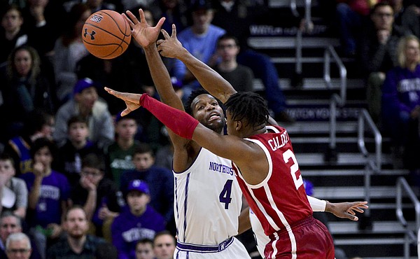 Oklahoma guard Aaron Calixte (2) passes the ball away from Northwestern forward Vic Law (4) during the first half of an NCAA college basketball game Friday, Dec. 21, 2018, in Evanston, Ill. (AP Photo/Matt Marton)