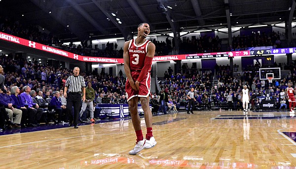 Oklahoma guard Miles Reynolds (3) celebrates the team's 76-69 overtime win against Northwestern in an NCAA college basketball game Friday, Dec. 21, 2018, in Evanston, Ill. (AP Photo/Matt Marton)