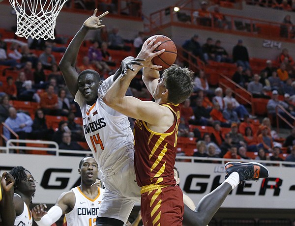 Iowa State forward Michael Jacobson (12) is fouled by Oklahoma State forward Yor Anei (14) during the second half of an NCAA college basketball game in Stillwater, Okla., Wednesday, Jan. 2, 2019. (AP Photo/Sue Ogrocki)