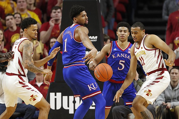 Iowa State's Talen Horton-Tucker, right, and Nick Weiler-Babb, left, fight for the ball with Kansas' Dedric Lawson, (1) and Quentin Grimes (5) during the first half of an NCAA college basketball game, Saturday, Jan. 5, 2019, in Ames, Iowa. 
