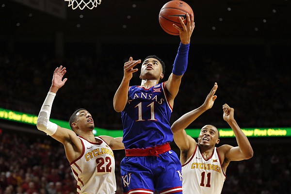 Kansas guard Devon Dotson, center, drives to the basket between Iowa State's Tyrese Haliburton, left, and Talen Horton-Tucker, right, during the second half of an NCAA college basketball game, Saturday, Jan. 5, 2019, in Ames, Iowa. (AP Photo/Charlie Neibergall)