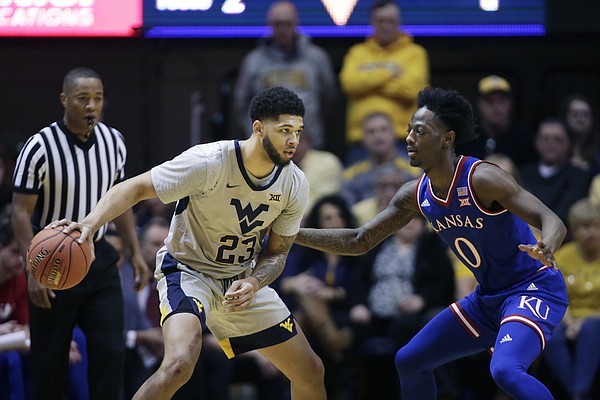 West Virginia forward Esa Ahmad (23) looks to make a pass while defended by Kansas guard Marcus Garrett (0) during the first half of an NCAA college basketball game Saturday, Jan. 19, 2019, in Morgantown, W.Va.