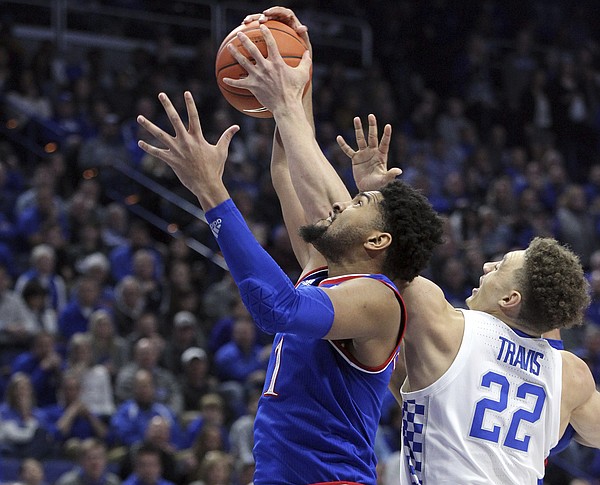 Kansas' Dedric Lawson, left, and Kentucky's Reid Travis (22) compete for a rebound during the first half of an NCAA college basketball game in Lexington, Ky., Saturday, Jan. 26, 2019.