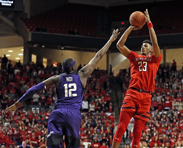Texas Tech's Jarrett Culver (23) jumps back to shoot the ball over TCU's Kouat Noi (12) during the second half of an NCAA college basketball game Monday, Jan. 28, 2019, in Lubbock, Texas. (AP Photo/Brad Tollefson)