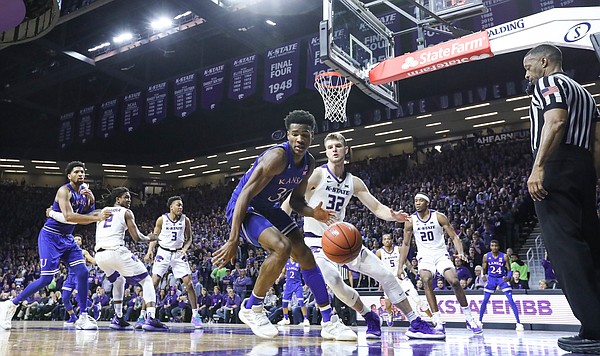 Kansas guard Ochai Agbaji (30) is defended by Kansas State forward Dean Wade (32) along the baseline during the second half, Tuesday, Feb. 5, 2019 at Bramlage Coliseum.