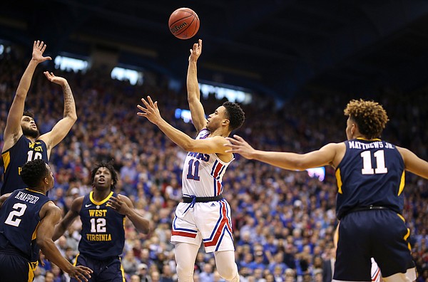 Kansas guard Devon Dotson (11) floats a shot over the West Virginia defense during the first half, Saturday, Feb. 16, 2019 at Allen Fieldhouse.