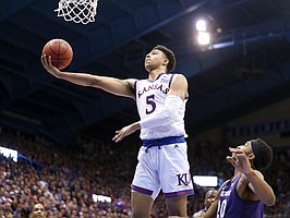 Kansas guard Quentin Grimes (5) swoops in for a bucket past Kansas State forward Xavier Sneed (20) during the second half, Monday, Feb. 25, 2019 at Allen Fieldhouse.