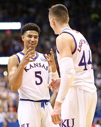Kansas guard Quentin Grimes (5) and Kansas forward Mitch Lightfoot (44) celebrate with little time remaining during the second half, Monday, Feb. 25, 2019 at Allen Fieldhouse.