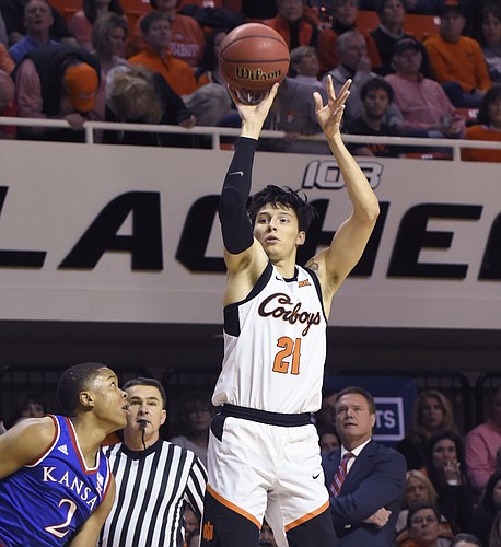 Kansas forward Charlie Moore, left, watches as Oklahoma State guard Lindy Waters III takes a shot during an NCAA college basketball game in Stillwater, Okla., Saturday, March 3, 2019. (AP Photo/Brody Schmidt)