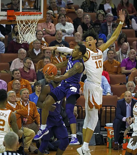 Kansas State guard Barry Brown, Jr., left, drives to the basket against Texas forward Jaxson Hayes during the first half of an NCAA college basketball game, Tuesday, Feb. 12, 2019, in Austin, Texas. (AP Photo/Michael Thomas)