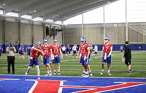 Kansas quarterback Miles Kendrick throws during football practice on Wednesday, March 6, 2019 within the new indoor practice facility.