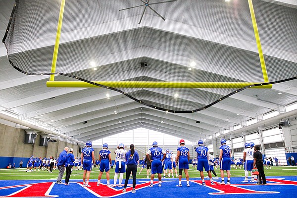 Kansas players line up in front of the south upright during football practice on Wednesday, March 6, 2019 within the new indoor practice facility.