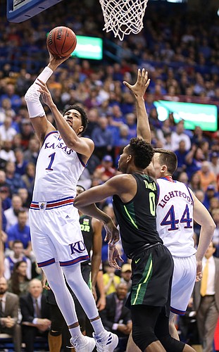 Kansas forward Dedric Lawson (1) puts in a bucket over Baylor forward Flo Thamba (0) during the first half, Saturday, March 9, 2019 at Allen Fieldhouse.