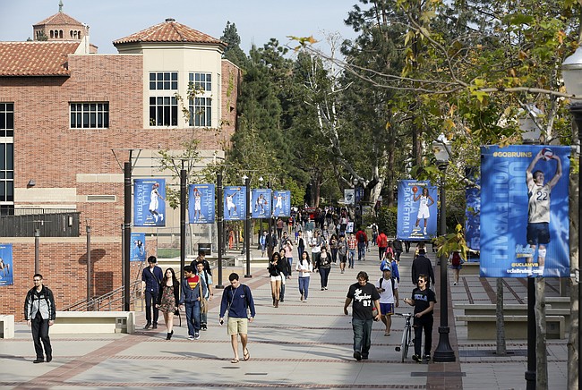 In this Feb. 26, 2015, file photo, students walk on the University of California, Los Angeles campus. (AP Photo/Damian Dovarganes, File)

