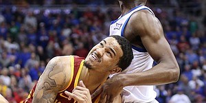 Kansas guard Marcus Garrett (0) and Iowa State guard Nick Weiler-Babb (1) battle for position on a loose ball during the first half, Saturday, March 16, 2019 at Sprint Center in Kansas City, Mo.
