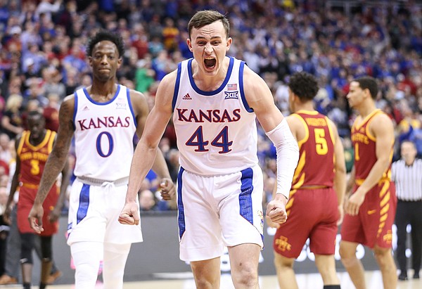 Kansas forward Mitch Lightfoot (44) celebrates a bucket and an Iowa State foul on Kansas guard Quentin Grimes (5) during the first half, Saturday, March 16, 2019 at Sprint Center in Kansas City, Mo.