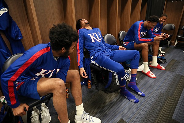 Kansas forward Dedric Lawson falls back into his locker while laughing with his brother K.J. Lawson on Friday, March 22, 2019 at Vivint Smart Homes Arena in Salt Lake City, Utah.