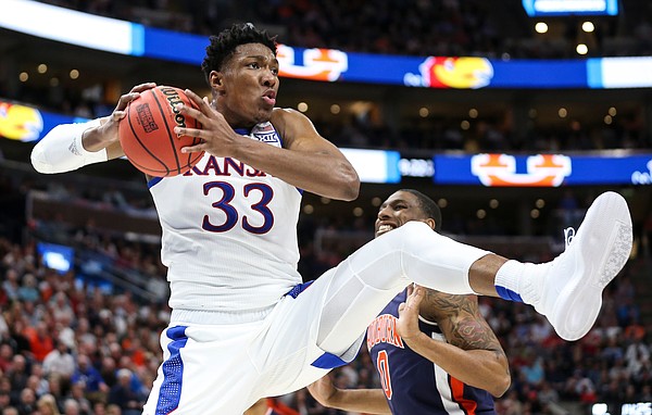 Kansas forward David McCormack (33) pulls away an offensive rebound from Auburn guard Samir Doughty (10) during the second half on Saturday, March 23, 2019 at Vivint Smart Homes Arena in Salt Lake City, Utah.