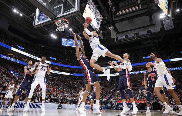Kansas guard Quentin Grimes (5) gets up for a bucket and a blocking foul on Auburn forward Horace Spencer (0) during the second half on Saturday, March 23, 2019 at Vivint Smart Homes Arena in Salt Lake City, Utah.