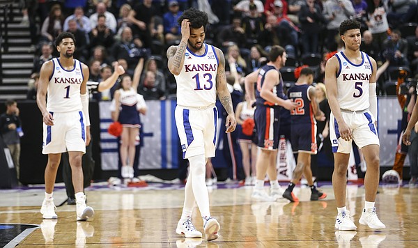 Kansas guard K.J. Lawson (13), Kansas forward Dedric Lawson (1) and Kansas guard Quentin Grimes (5) leave the court as the buzzer sounds the end of the game on Saturday, March 23, 2019 at Vivint Smart Homes Arena in Salt Lake City, Utah.