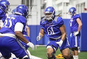 Kansas offensive lineman Malik Clark works with his fellow position players on Thursday, April 4, 2019 at the indoor practice facility.